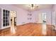 Spacious room with hardwood floors and views to the staircase, bathroom and french doors at 510 Aiken Dr, Dallas, GA 30157