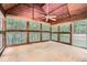 Bright sunroom featuring a wood ceiling, bamboo blinds, and many windows showcasing the surrounding landscape at 510 Aiken Dr, Dallas, GA 30157