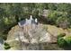 Aerial view of the home showcasing its sprawling layout, wooded surroundings, and circular driveway, providing a sense of privacy at 5360 Northwater Way, Duluth, GA 30097