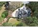 Aerial view of the estate showing the circular driveway, back deck, multiple garages, and lush greenery at 5360 Northwater Way, Duluth, GA 30097