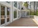 Expansive back deck featuring large windows, french doors, and surrounding nature views, ideal for seamless indoor-outdoor living at 5360 Northwater Way, Duluth, GA 30097
