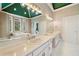 Elegant bathroom featuring dual sinks, marble countertops, and a luxurious soaking tub with natural light at 5360 Northwater Way, Duluth, GA 30097