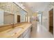 Unique bathroom with floral wallpaper, marble countertop, lots of mirrors and gold shower accents at 5360 Northwater Way, Duluth, GA 30097