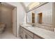 Bright bathroom with stone countertops, a large mirror, and a separate toilet room at 5360 Northwater Way, Duluth, GA 30097