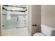 Bathroom featuring sleek black and white shower tile, a glass shower door, and minimalist hardware at 5360 Northwater Way, Duluth, GA 30097