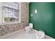 Cozy half bathroom with a toilet and bidet accented with beautiful floral wallpaper at 5360 Northwater Way, Duluth, GA 30097