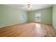 Comfortable bedroom featuring wood floors, a ceiling fan, and a lovely shade of green paint at 5360 Northwater Way, Duluth, GA 30097