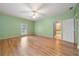 Comfortable bedroom featuring wood floors, a ceiling fan, a great paint color and en-suite bath access at 5360 Northwater Way, Duluth, GA 30097