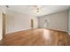 Spacious bedroom featuring gleaming hardwood floors, a ceiling fan and lots of natural light at 5360 Northwater Way, Duluth, GA 30097