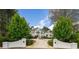 Stately home with symmetrical design, prominent columns, circular driveway, and lush greenery creating a luxurious curb appeal at 5360 Northwater Way, Duluth, GA 30097