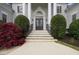 Elegant home entrance featuring stately columns, double doors, and manicured landscaping, creating a grand arrival at 5360 Northwater Way, Duluth, GA 30097