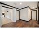 Hallway with doors, dark trim, and hardwood flooring at 5360 Northwater Way, Duluth, GA 30097