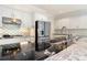 Modern kitchen with sleek black countertops, white cabinets, and stainless steel appliances at 5360 Northwater Way, Duluth, GA 30097