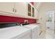 Functional laundry room with a washing machine, dryer, sink, and ample storage space at 5360 Northwater Way, Duluth, GA 30097