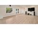 Large living room with light floors, white walls, outdoor access and a large television at 5360 Northwater Way, Duluth, GA 30097