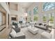 Bright living room with soaring ceilings, large windows, and a cozy fireplace at 5360 Northwater Way, Duluth, GA 30097