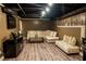 Basement features a large sectional sofa, laminate flooring and track lighting at 910 Kings Arms Way, Alpharetta, GA 30022