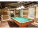 Basement features a pool table, laminate flooring and a bar area at 910 Kings Arms Way, Alpharetta, GA 30022
