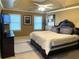 Bedroom features neutral carpet, modern ceiling fan and tray ceiling at 910 Kings Arms Way, Alpharetta, GA 30022