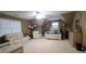 Spacious bedroom features ample seating, neutral carpet and a ceiling fan at 910 Kings Arms Way, Alpharetta, GA 30022
