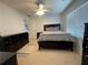 Bedroom features neutral carpet, ceiling fan, and a large window for natural light at 910 Kings Arms Way, Alpharetta, GA 30022
