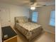 Cozy bedroom featuring neutral decor, comfortable bedding, and ample natural light at 910 Kings Arms Way, Alpharetta, GA 30022