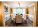 Dining room featuring hardwood floors, bay window, wainscoting, and seating for ten at 910 Kings Arms Way, Alpharetta, GA 30022