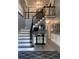 Elegant foyer features a staircase with black iron railings and decorative accents at 910 Kings Arms Way, Alpharetta, GA 30022