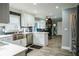 Bright kitchen featuring stainless steel appliances, modern white cabinetry, and an eat-in dining area at 910 Kings Arms Way, Alpharetta, GA 30022