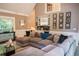Spacious living room with wet bar, comfortable sectional sofa, and plenty of natural light at 910 Kings Arms Way, Alpharetta, GA 30022