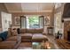 Relaxing living room with a stone fireplace, comfortable sofa, and access to outdoor patio at 910 Kings Arms Way, Alpharetta, GA 30022