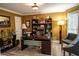 Comfortable home office with a large desk, shelving, decor, and ample lighting at 910 Kings Arms Way, Alpharetta, GA 30022