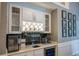 Stylish wet bar boasts custom cabinets, wine storage, and a modern design at 910 Kings Arms Way, Alpharetta, GA 30022