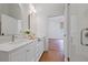 Bright bathroom featuring double sinks, marble countertops, and a shower with glass doors at 95 Whitlock Sw Ave, Marietta, GA 30064