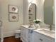 Elegant bathroom featuring a double vanity with quartz countertops, modern fixtures, and beautiful mirrors at 95 Whitlock Sw Ave, Marietta, GA 30064