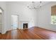 Spacious bedroom with hardwood floors, a fireplace, and a window with natural light at 95 Whitlock Sw Ave, Marietta, GA 30064