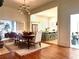 Bright dining room showcasing hardwood floors, a modern chandelier, and views into the open kitchen at 95 Whitlock Sw Ave, Marietta, GA 30064