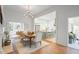 This dining room features a modern chandelier, hardwood floors, and open access to the kitchen and living areas at 95 Whitlock Sw Ave, Marietta, GA 30064