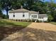 A white home has a driveway and freshly manicured yard at 95 Whitlock Sw Ave, Marietta, GA 30064