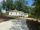 A white home has a concrete driveway and freshly manicured yard at 95 Whitlock Sw Ave, Marietta, GA 30064