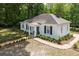 Charming white home featuring a cozy front porch, black shutters and lush landscaping at 95 Whitlock Sw Ave, Marietta, GA 30064