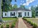 A quaint home with neat landscaping, a symmetrical facade, and a welcoming entrance at 95 Whitlock Sw Ave, Marietta, GA 30064
