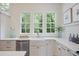 Bright kitchen with a stainless dishwasher, and a large window to the backyard at 95 Whitlock Sw Ave, Marietta, GA 30064