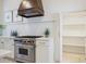 Modern kitchen features a stainless stove with a custom vent hood at 95 Whitlock Sw Ave, Marietta, GA 30064