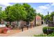 Inviting outdoor seating area with tables and chairs amidst lush greenery in a town square at 95 Whitlock Sw Ave, Marietta, GA 30064