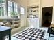 Bright sunroom with checkerboard rug, built-in shelving, and a large window for ample natural light at 95 Whitlock Sw Ave, Marietta, GA 30064