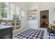 Sunroom with built-in shelving, a bench, and a patterned rug at 95 Whitlock Sw Ave, Marietta, GA 30064