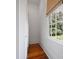 Walk-in closet with hardwood floors, storage shelves, and a large window overlooking the yard at 95 Whitlock Sw Ave, Marietta, GA 30064