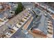An aerial view displays a well-maintained neighborhood with neatly arranged townhomes and landscaping at 1212 Lake Point Way, Suwanee, GA 30024