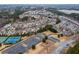 Aerial view of community with tennis courts, playground, and parking lot at 1212 Lake Point Way, Suwanee, GA 30024